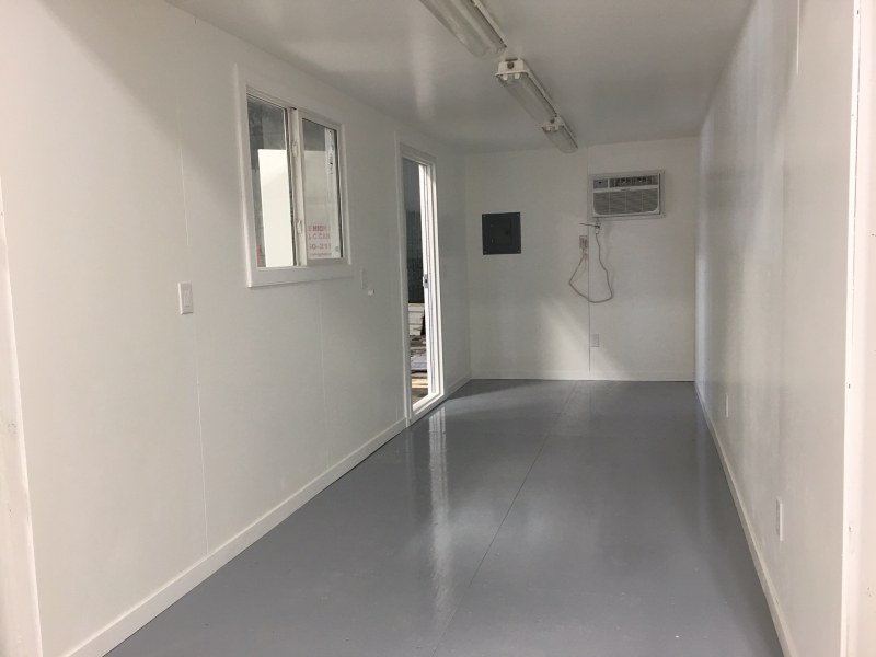 white interior of a c-can converted into an office at ace high storage