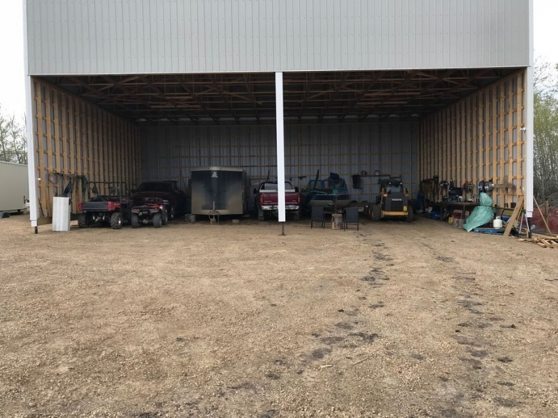 covered storage area at ace high storage in dawson creek filled with trucks, trailers, and recreational vehicles